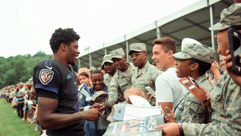 Lamar Jackson interacts with troops