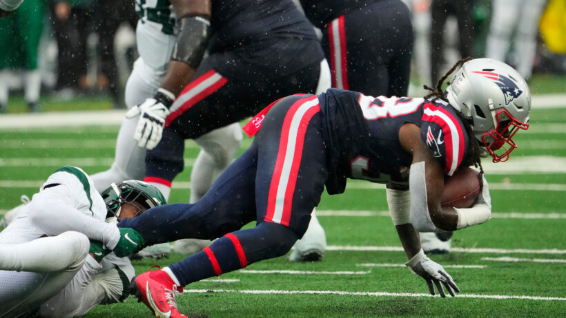 New York Jets safety Jordan Whitehead tackling New England Patriots running back Rhamondre Stevenson