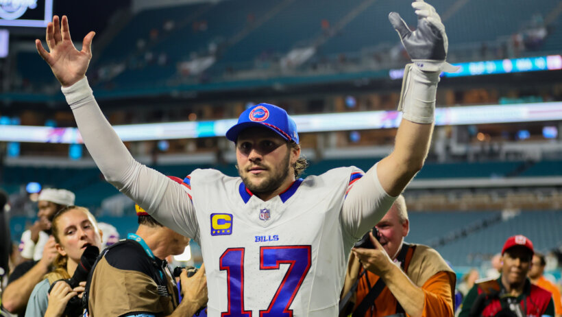 Josh Allen with his hands in the air