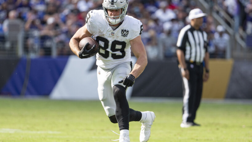 Brock Bowers running with the football
