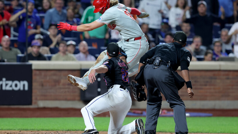 New York Mets starting pitcher David Peterson tags out Philadelphia Phillies third baseman Alec Bohm