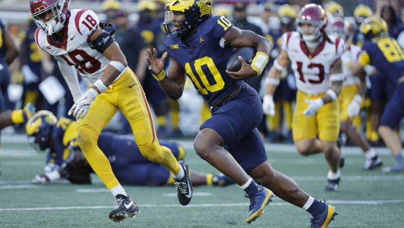 Michigan Wolverines quarterback Alex Orji runs in the second half