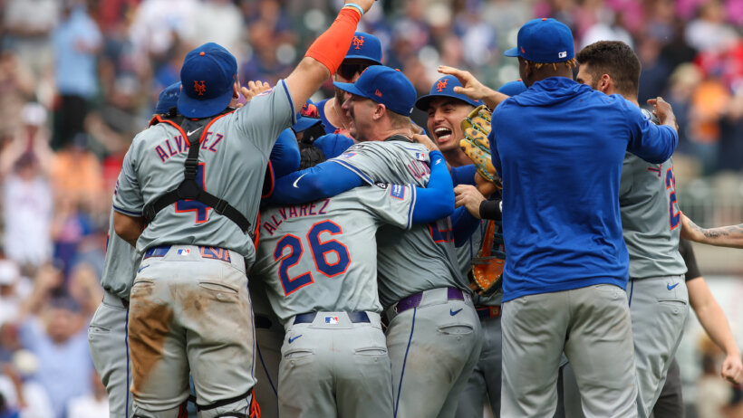 The New York Mets celebrate clinching a playoff berth