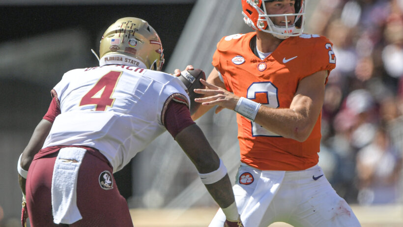 Florida State Seminoles linebacker Karen DeLoach hits Clemson Tigers quarterback Cade Klubnik To knock the ball loose