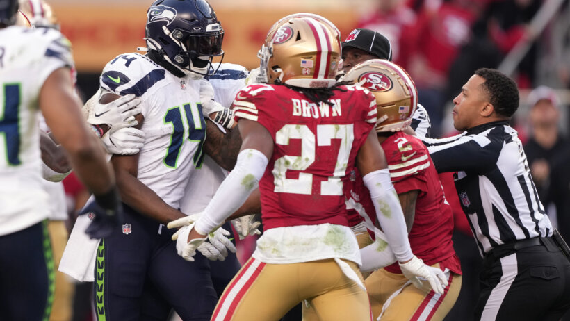 Seahawks and 49ers players in a heated exchange on the field