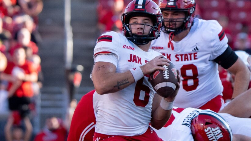 Tyler Huff escapes pressure in the pocket against Louisville.