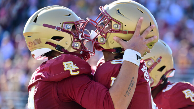 Boston College Eagles quarterback Grayson James celebrates a touchdown with defensive lineman Ty Clemons
