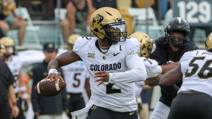 Colorado Buffaloes quarterback Shedeur Sanders rolls out to pass against the UCF Knights