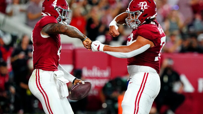 Alabama Crimson Tide quarterback Jalen Milroe celebrates with offensive lineman Parker Brailsford