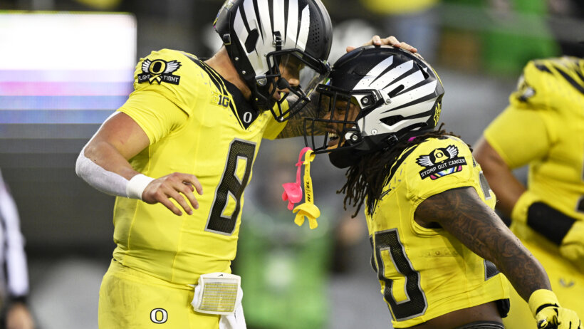 Oregon Ducks quarterback Dillon Gabriel celebrates after scoring a touchown with running back Jordan James