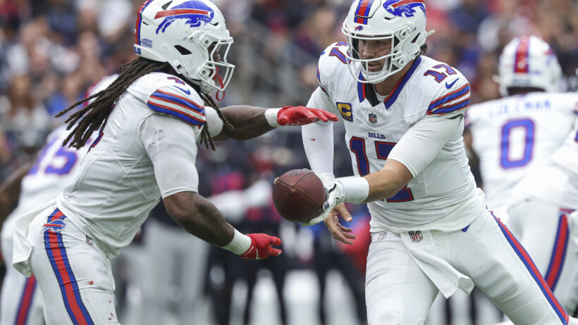 Josh Allen handing the ball off to James Cook