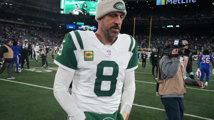 New York Jets QB Aaron Rodgers walks off the field after a loss to the Buffalo Bills