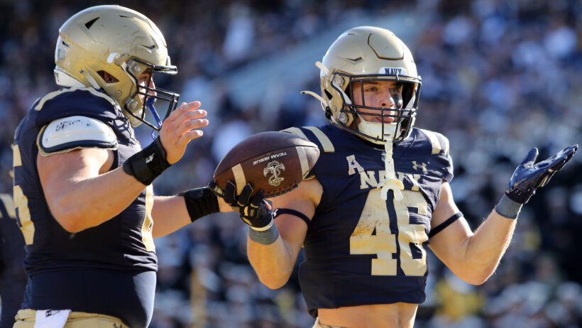 Navy Midshipmen fullback Alex Tecza celebrates after scoring a touchdown