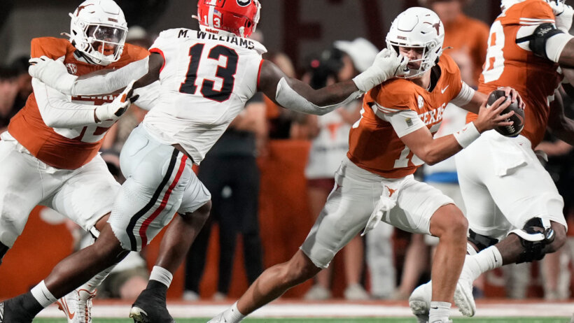 Georgia Bulldogs defensive lineman Mykel Williams grabs the facemask of Texas Longhorns quarterback Arch Manning