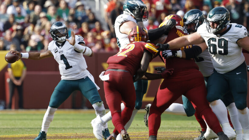 Philadelphia Eagles quarterback Jalen Hurts throwing a pass against the Washington Commanders
