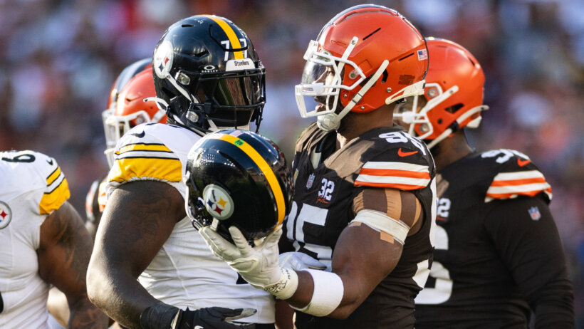Cleveland Browns defensive end Myles Garrett hands a helmet back to Pittsburgh Steelers offensive tackle Broderick Jones