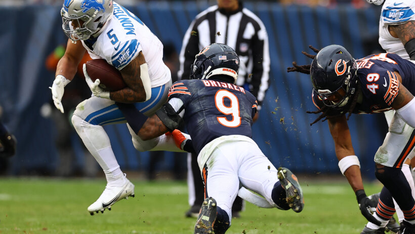 Chicago Bears safety Jaquan Brisker tackling Detroit Lions running back David Montgomery