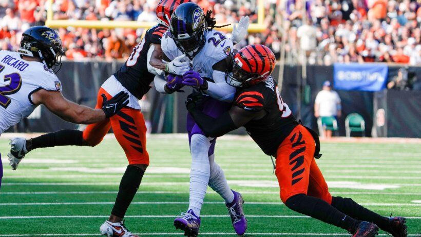 Baltimore Ravens running back Derrick Henry tries to fight through a tackle against the Cincinnati Bengals