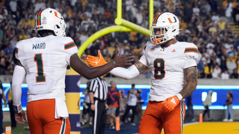 Cam Ward celebrates a touchdown with his teammates.
