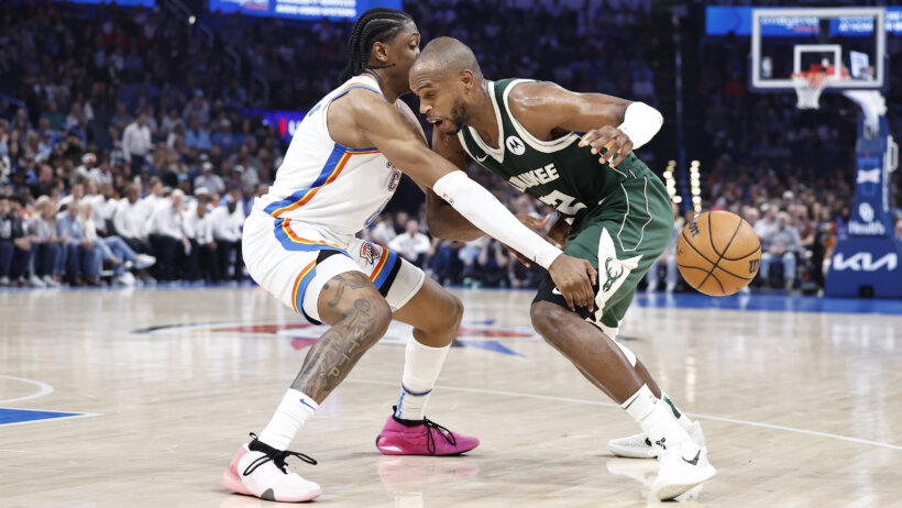 Oklahoma City Thunder forward Jalen Williams pokes the ball away from Milwaukee Bucks forward Khris Middleton