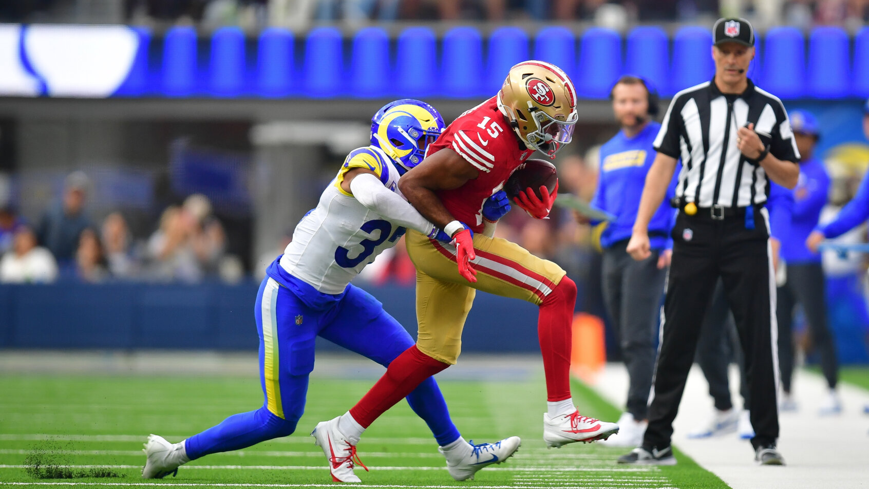 San Francisco 49ers wide receiver Jauan Jennings getting pushed out of bounds by Los Angeles Rams safety Quentin Lake