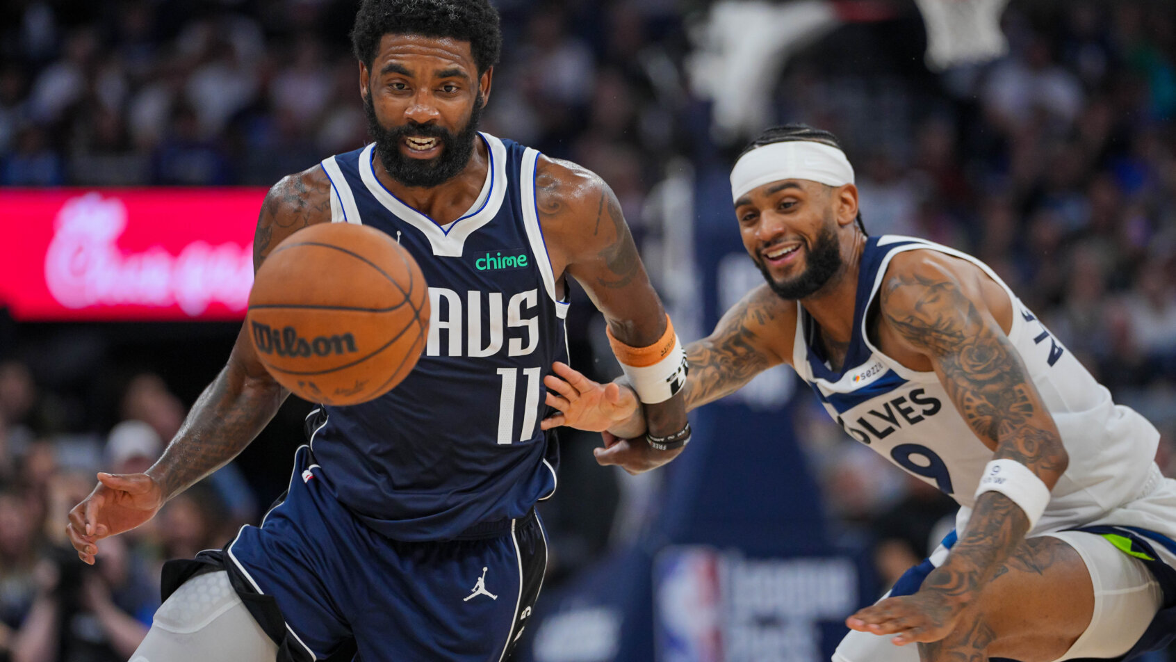 Dallas Mavericks guard Kyrie Irving dribbles around Minnesota Timberwolves guard Nickeil Alexander-Walker