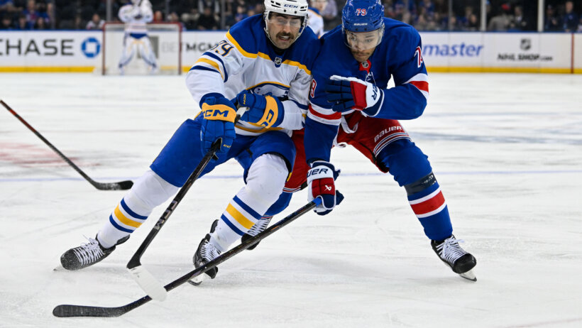 Buffalo Sabres right wing Alex Tuch and New York Rangers defenseman K'Andre Miller battle for the puck