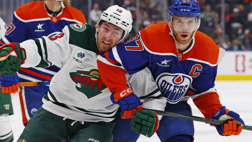 Edmonton Oilers forward Connor McDavid (97) and Minnesota Wild forward Yakov Trenin battle for position