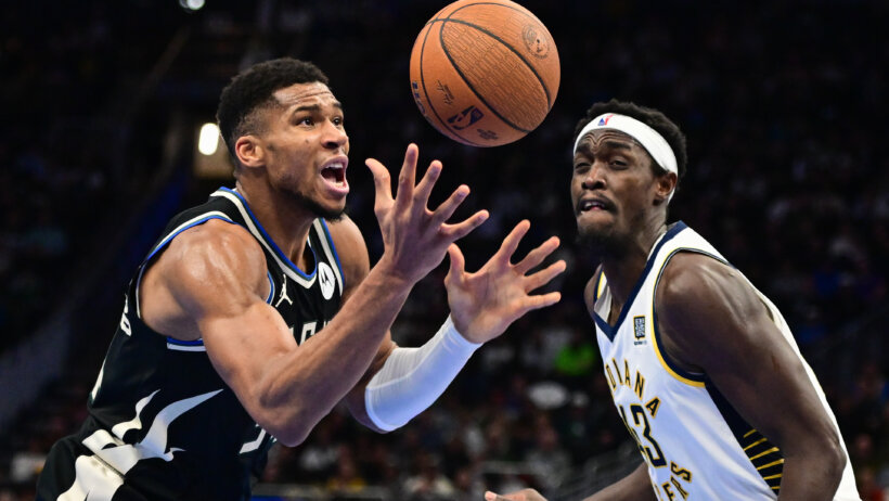 Milwaukee Bucks forward Giannis Antetokounmpo battles for a loose ball against and Indiana Pacers forward Pascal Siakam