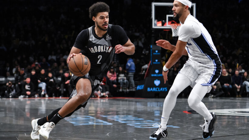 Brooklyn Nets forward Cameron Johnson tries to drive past Orlando Magic guard Jalen Suggs