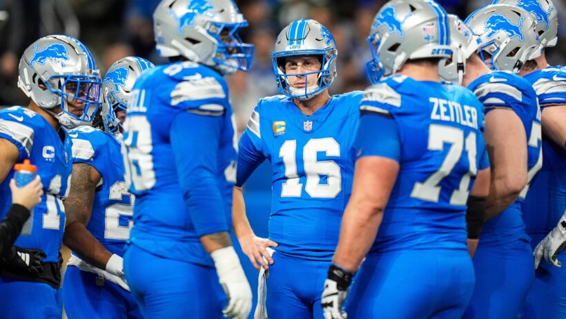 Detroit Lions quarterback Jared Goff huddling with teammates