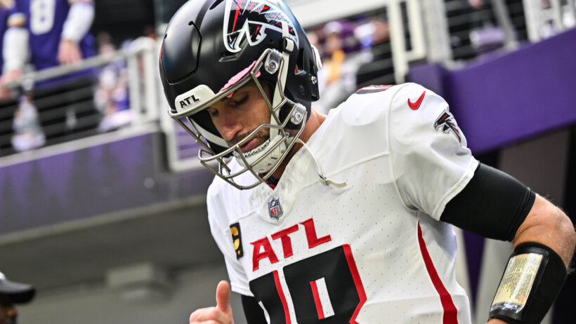 Kirk Cousins runs out from the tunnel in Minnesota.