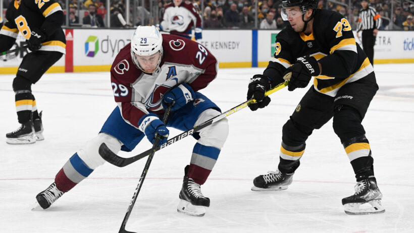 Massachusetts, USA; Boston Bruins defenseman Charlie McAvoy defends Colorado Avalanche center Nathan MacKinnon