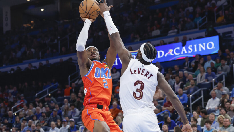 Oklahoma City Thunder guard Shai Gilgeous-Alexander shoots over Cleveland Cavaliers guard Caris LeVert