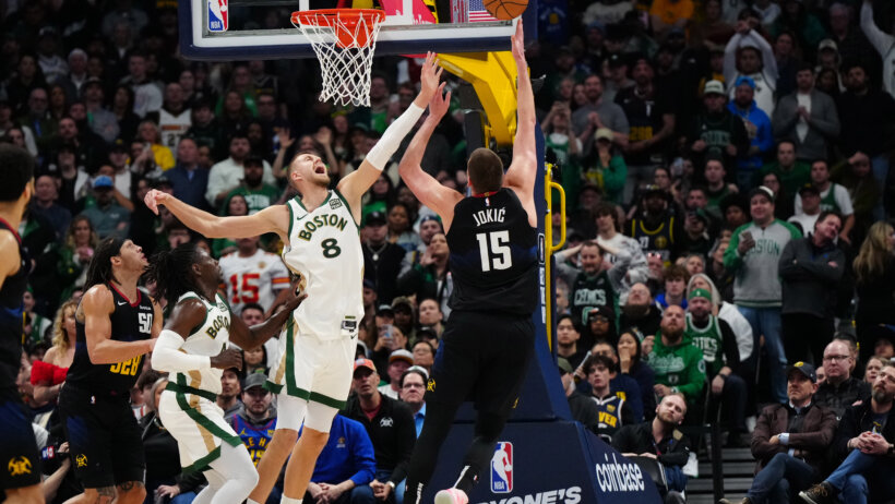 Denver Nuggets center Nikola Jokic shooting over Boston Celtics center Kristaps Porzingis