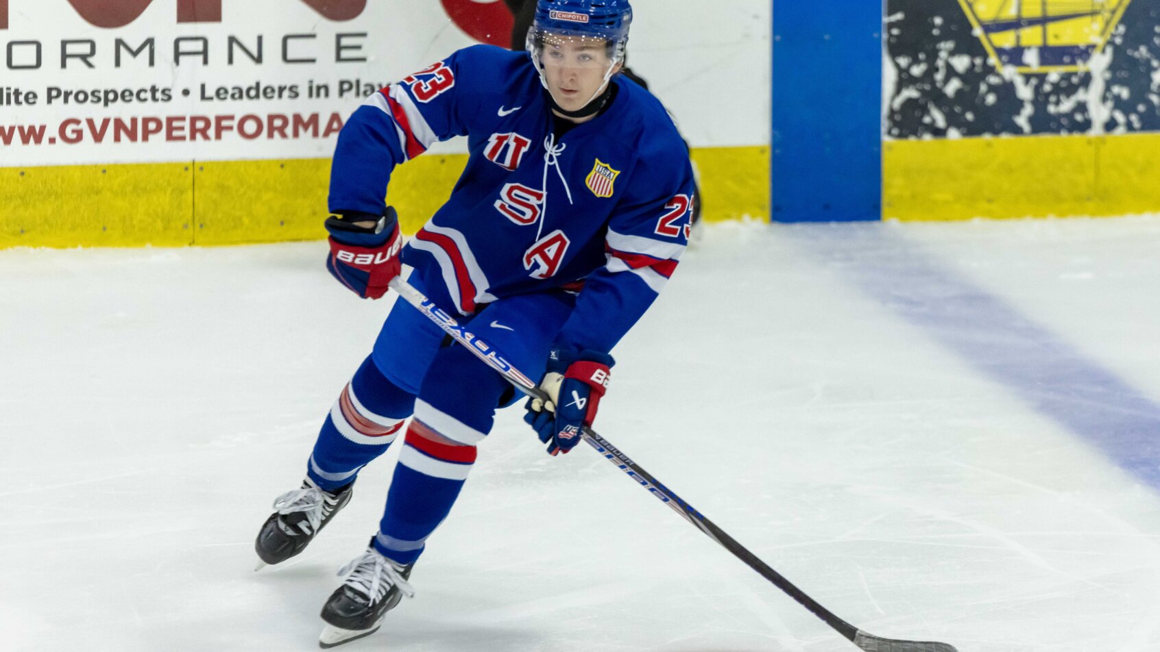 Team defenceman Cole Hutson skating with the puck