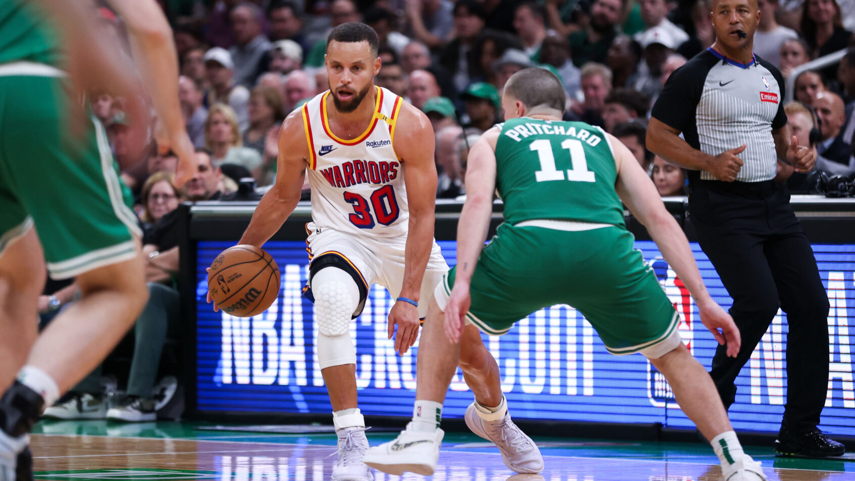 Golden State Warriors guard Stephen Curry dribbling as Boston Celtics guard Payton Pritchard defends