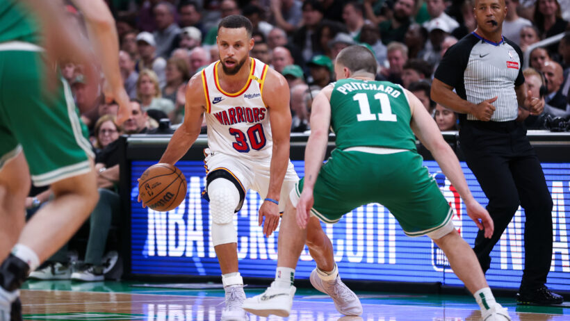 Golden State Warriors guard Stephen Curry dribbling as Boston Celtics guard Payton Pritchard defends