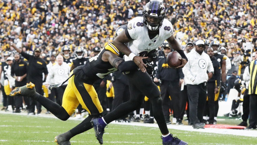 Lamar Jackson is chased down by a Steelers defender.