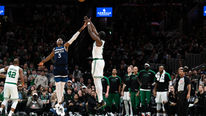 Boston Celtics guard Jaylen Brown shooting a jumper over Minnesota Timberwolves forward Jaden McDaniels