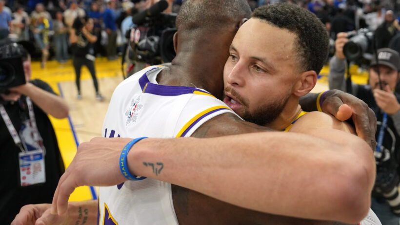 LeBron James and Steph Curry embrace after a game.