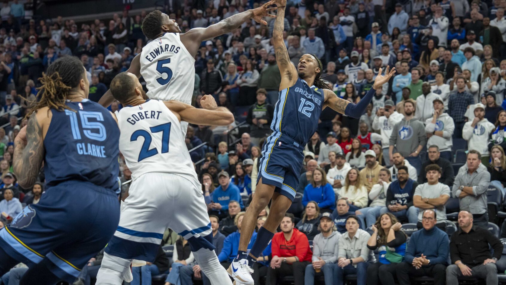 Memphis Grizzlies guard Ja Morant shoots over Minnesota Timberwolves guard Anthony Edwards