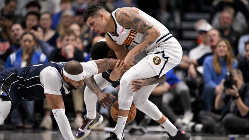 Dallas Mavericks center Daniel Gafford fights for a loose ball with Denver Nuggets forward Michael Porter Jr