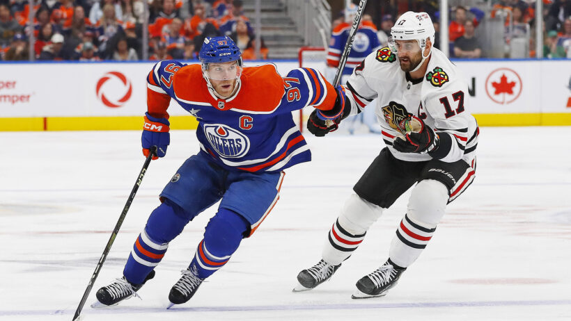 Edmonton Oilers forward Connor McDavid carries the puck around Chicago Blackhawks forward Nick Foligno