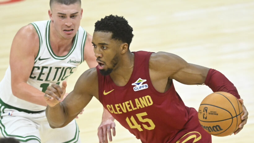 Cleveland Cavaliers guard Donovan Mitchell dribbles around Boston Celtics guard Payton Pritchard
