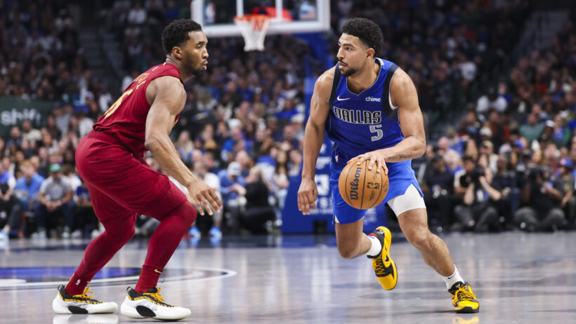 Dallas Mavericks guard Quentin Grimes tries to dribble around Cleveland Cavaliers guard Donovan Mitchell
