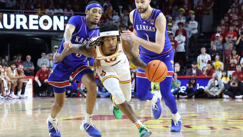 Iowa State Cyclones guard Keshon Gilbert drives past two Kansas Jayhawks defenders