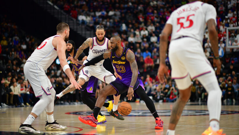 Los Angeles Lakers forward LeBron James maneuvers between three LA Clippers players