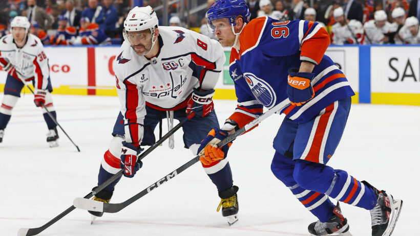 Oilers forward Corey Perry and Washington Capitals forward Alex Ovechkin look for a loose puck