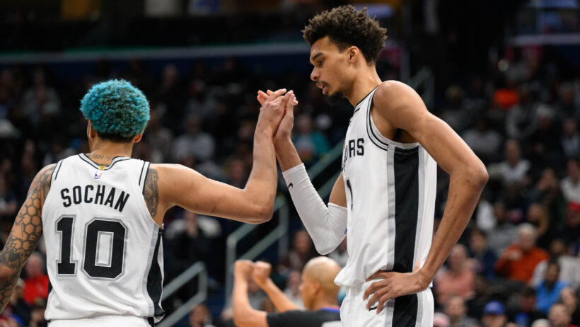 San Antonio Spurs center Victor Wembanyama high-fives teammate Jeremy Sochan